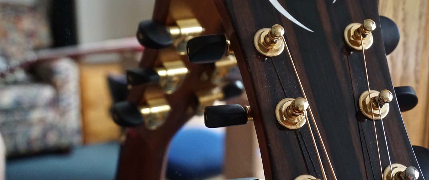 guitar leaning against a mirror