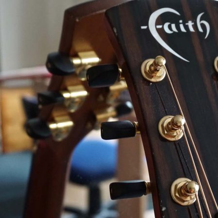 guitar leaning against a mirror