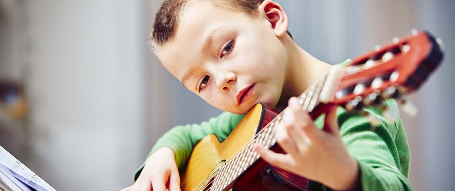 boy playing the guitar