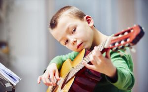 boy playing the guitar