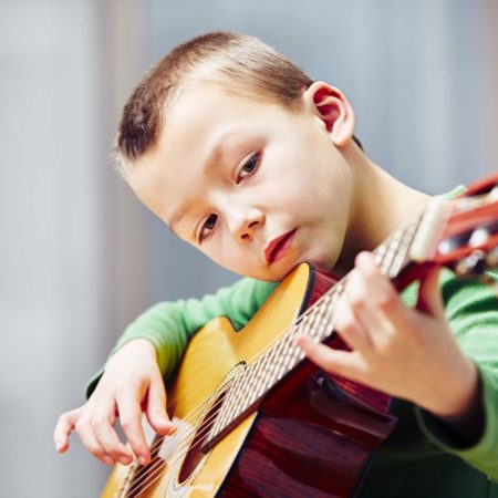 boy playing the guitar