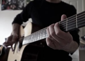 Richard Hunt playing acoustic guitar.