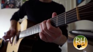 Richard Hunt playing acoustic guitar.